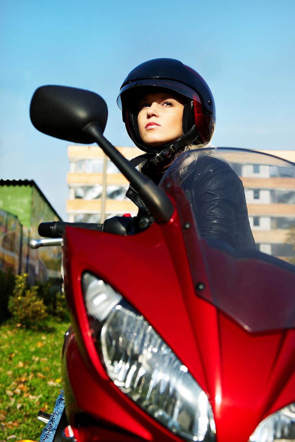 The blonde in a helmet on a red motorcycle